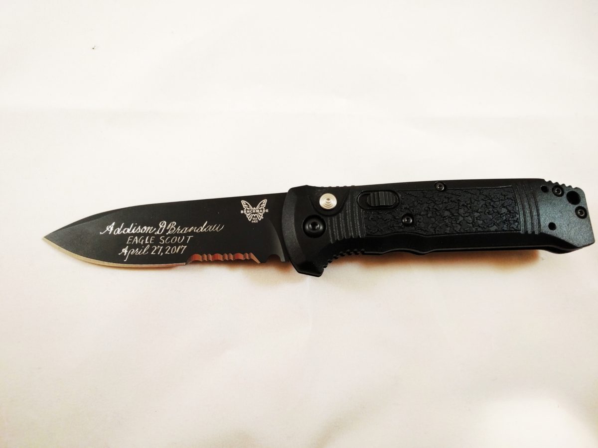 benchmark knives with an eagle symbol on blade